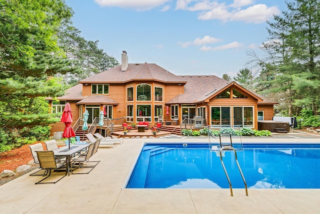 17 Lake Ct, North Oaks, MN 55127 - outdoor pool with a hot tub, a wooden deck, a patio, and outdoor dining area