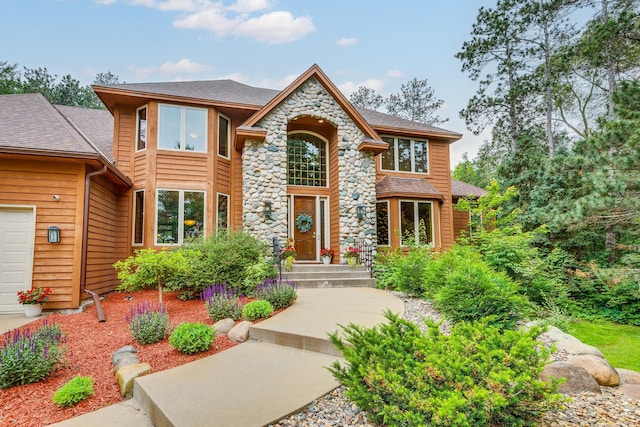 17 Lake Ct, North Oaks, MN 55127 - view of front of property with roof with shingles and stone siding