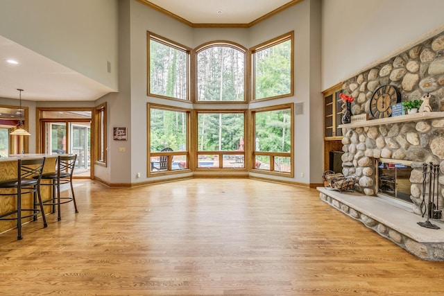 17 Lake Ct, North Oaks, MN 55127 - living area featuring wood finished floors, a towering ceiling, a fireplace, crown molding, and recessed lighting