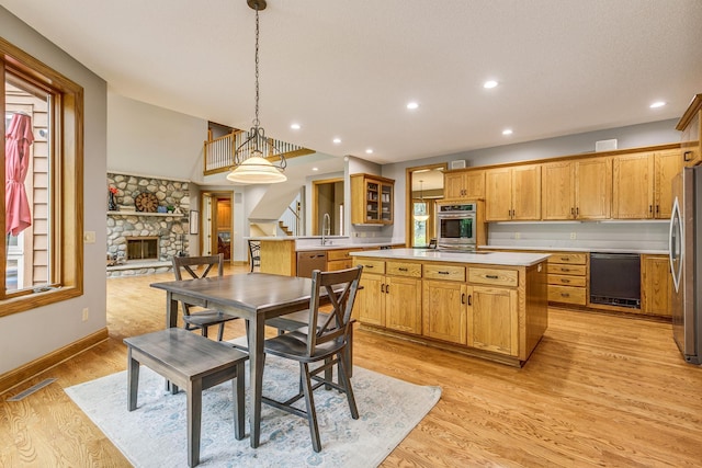 17 Lake Ct, North Oaks, MN 55127 - dining area featuring a stone fireplace, stairs, recessed lighting, and light wood-style floors