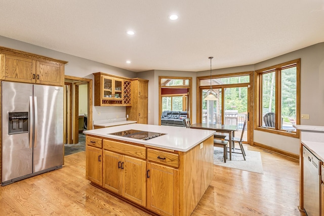 17 Lake Ct, North Oaks, MN 55127 - kitchen with stainless steel fridge with ice dispenser, light wood-style flooring, black electric stovetop, recessed lighting, and a center island