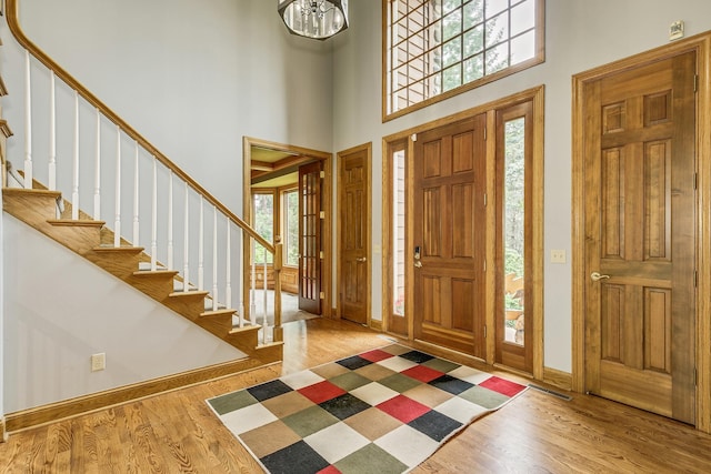17 Lake Ct, North Oaks, MN 55127 - entryway featuring a towering ceiling, wood finished floors, and stairs