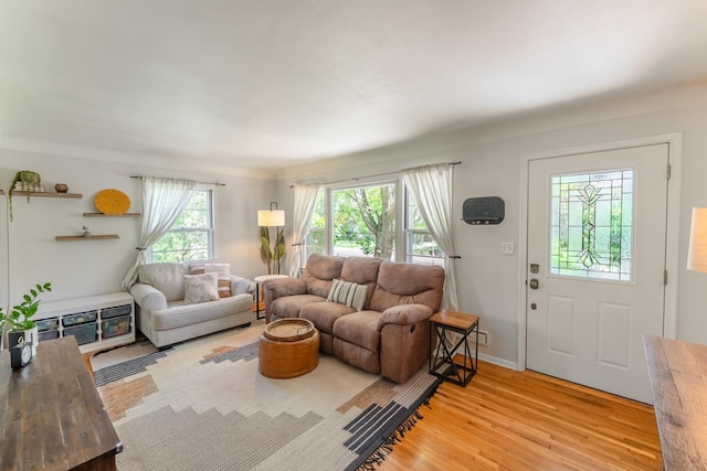 living area featuring light wood-type flooring and baseboards