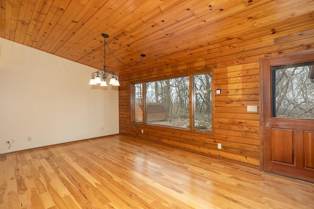 34126 County 115, Canton Twp, MN 55939 - unfurnished dining area featuring a chandelier, vaulted ceiling, light wood-type flooring, wooden ceiling, and wooden walls