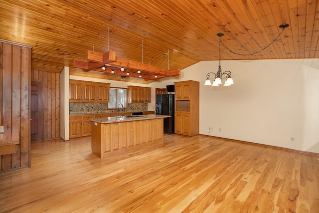 34126 County 115, Canton Twp, MN 55939 - kitchen featuring freestanding refrigerator, lofted ceiling, a chandelier, light wood-style floors, and a sink
