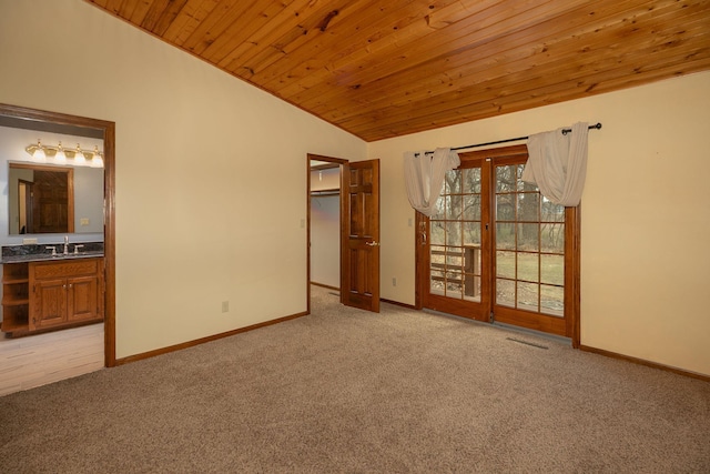 34126 County 115, Canton Twp, MN 55939 - unfurnished bedroom featuring lofted ceiling, light colored carpet, a sink, wood ceiling, and baseboards
