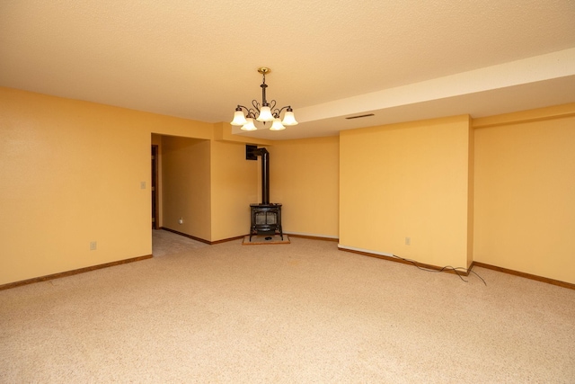 34126 County 115, Canton Twp, MN 55939 - spare room with a wood stove, light carpet, and baseboards
