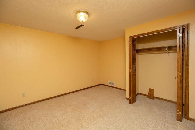 34126 County 115, Canton Twp, MN 55939 - unfurnished bedroom featuring light colored carpet, a closet, and a textured ceiling