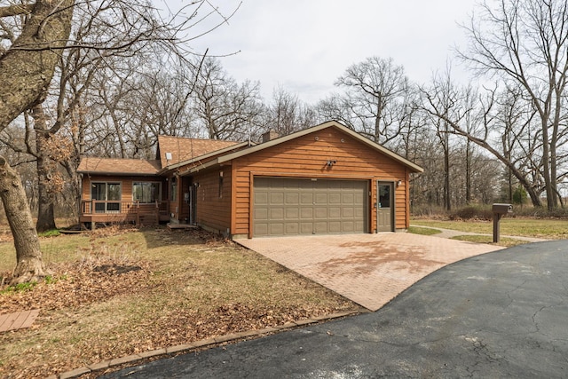 34126 County 115, Canton Twp, MN 55939 - view of front of property with decorative driveway, an attached garage, a shingled roof, and a front yard