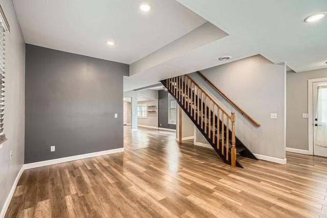 1907 University Ave NE, Minneapolis, MN 55418 - unfurnished living room featuring stairs, wood finished floors, baseboards, and recessed lighting