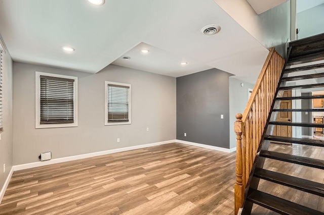 1907 University Ave NE, Minneapolis, MN 55418 - unfurnished room with baseboards, wood finished floors, stairs, and recessed lighting