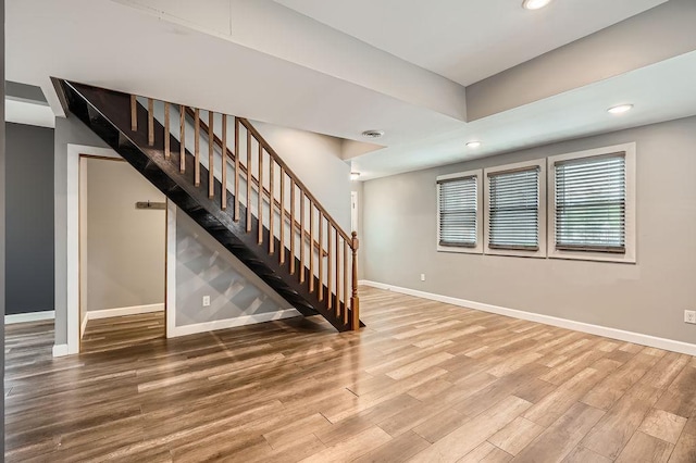 1907 University Ave NE, Minneapolis, MN 55418 - unfurnished living room with baseboards, wood finished floors, stairs, and recessed lighting