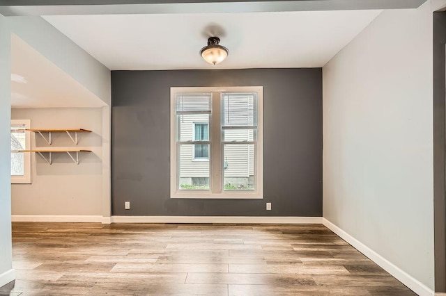 1907 University Ave NE, Minneapolis, MN 55418 - unfurnished room featuring wood finished floors, baseboards, and healthy amount of natural light