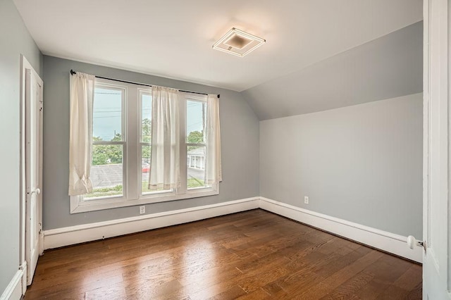 1907 University Ave NE, Minneapolis, MN 55418 - bonus room featuring lofted ceiling, dark wood-type flooring, baseboards, and a baseboard heating unit