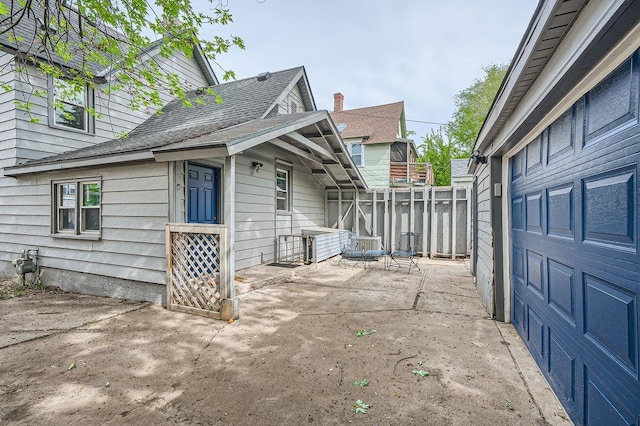 1907 University Ave NE, Minneapolis, MN 55418 - view of home's exterior with a patio and roof with shingles