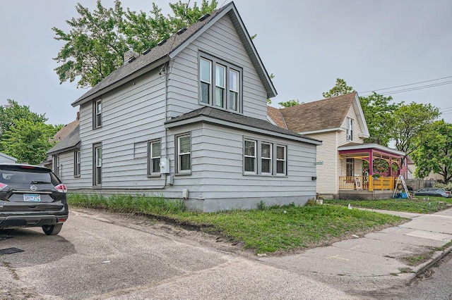 1907 University Ave NE, Minneapolis, MN 55418 - view of side of home featuring roof with shingles