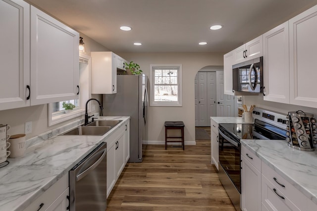 2730 State 371 SW, Pine River, MN 56474 - kitchen with white cabinets, light wood-style flooring, a sink, recessed lighting, and appliances with stainless steel finishes