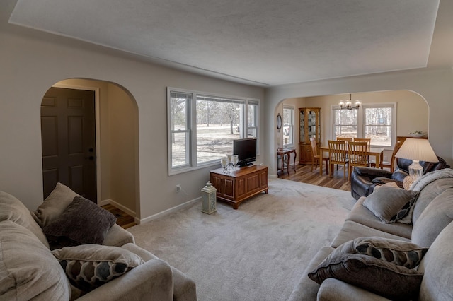 2730 State 371 SW, Pine River, MN 56474 - living area with light colored carpet, arched walkways, a notable chandelier, and baseboards