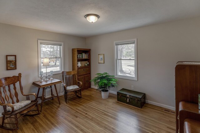 2730 State 371 SW, Pine River, MN 56474 - sitting room featuring wood finished floors, visible vents, and baseboards