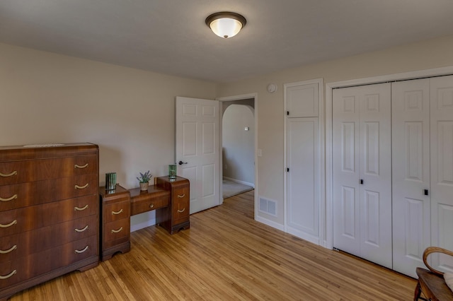 2730 State 371 SW, Pine River, MN 56474 - bedroom with a closet, light wood-type flooring, arched walkways, baseboards, and visible vents