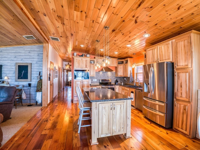 23660 Cap Endres Rd NE, Cass Lake, MN 56633 - kitchen with stainless steel appliances, dark countertops, open floor plan, wooden ceiling, and light wood-style flooring