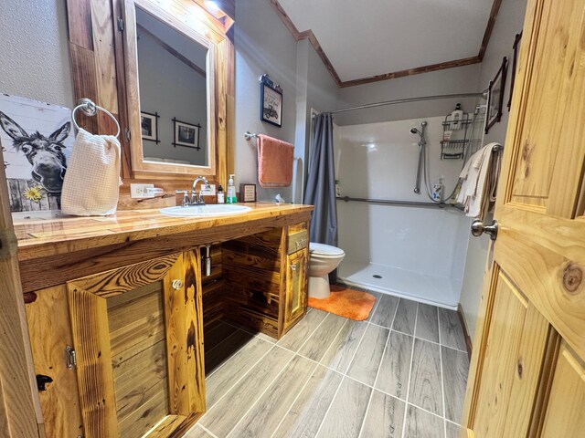 23660 Cap Endres Rd NE, Cass Lake, MN 56633 - bathroom featuring crown molding, toilet, a shower with curtain, vanity, and wood finished floors