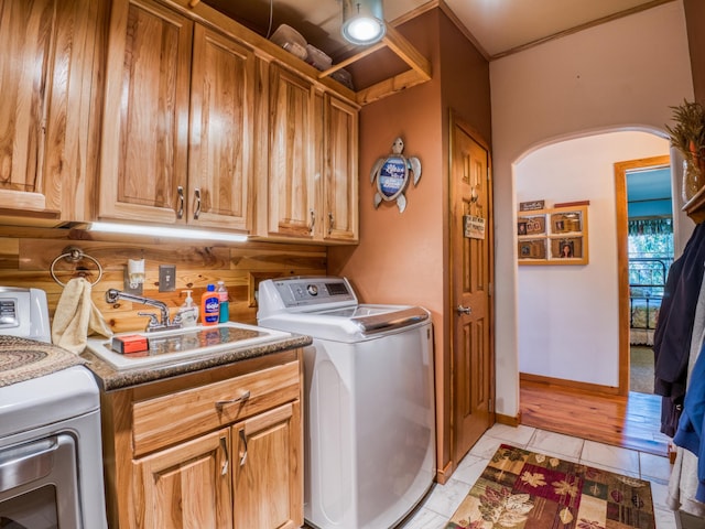 23660 Cap Endres Rd NE, Cass Lake, MN 56633 - laundry room featuring washing machine and clothes dryer, cabinet space, and baseboards