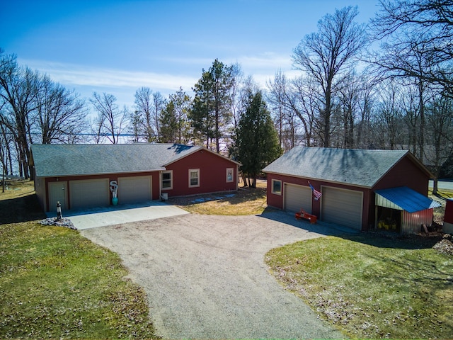23660 Cap Endres Rd NE, Cass Lake, MN 56633 - view of front of property with dirt driveway, a detached garage, a front yard, and roof with shingles