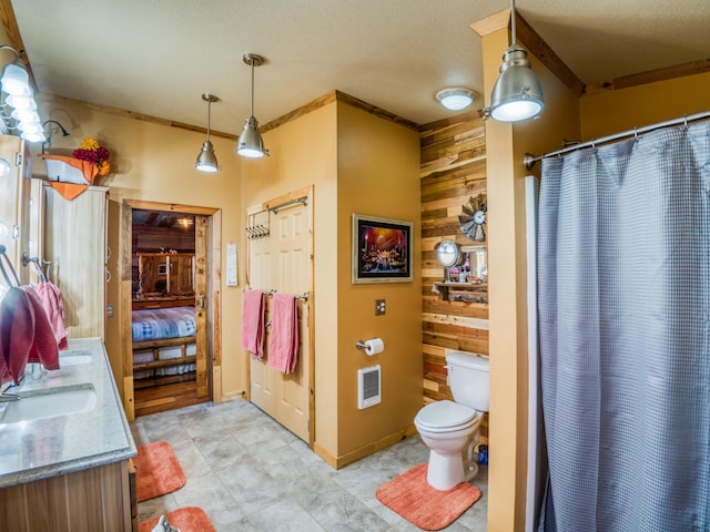 23660 Cap Endres Rd NE, Cass Lake, MN 56633 - full bathroom featuring double vanity, wooden walls, toilet, heating unit, and a shower with shower curtain