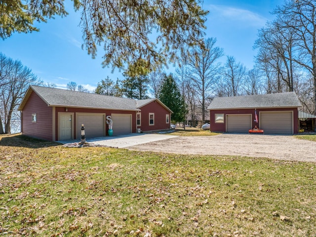 23660 Cap Endres Rd NE, Cass Lake, MN 56633 - view of side of home featuring driveway, a yard, an outbuilding, and an attached garage