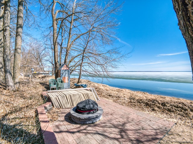 23660 Cap Endres Rd NE, Cass Lake, MN 56633 - view of patio featuring a fire pit and a water view