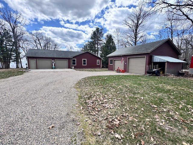 23660 Cap Endres Rd NE, Cass Lake, MN 56633 - view of property exterior with an outbuilding, a garage, and roof with shingles