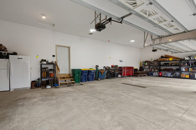 6570 Chester Ave, Webster Twp, MN 55057 - garage featuring freestanding refrigerator, a garage door opener, and a workshop area