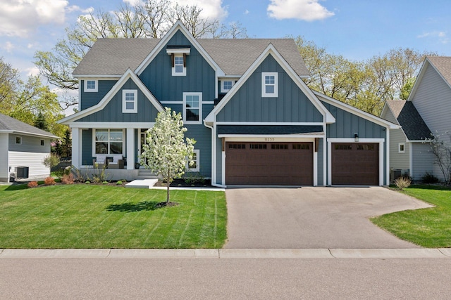 craftsman-style home with covered porch, board and batten siding, driveway, and a front lawn