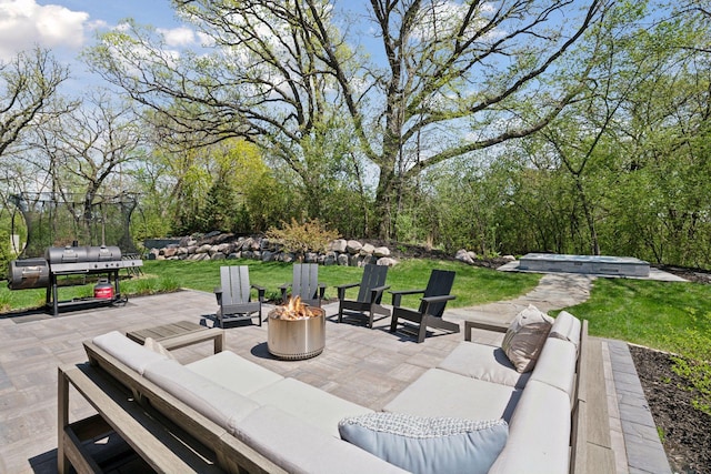 view of patio / terrace featuring an outdoor living space with a fire pit