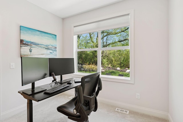 carpeted home office featuring baseboards, a healthy amount of sunlight, and visible vents