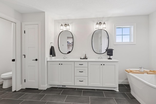 full bathroom with a sink, double vanity, and tile patterned floors