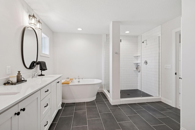 bathroom with a stall shower, a sink, a soaking tub, a textured ceiling, and tile patterned flooring