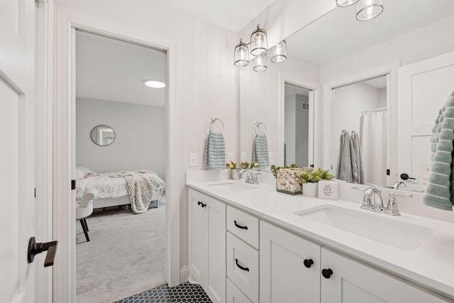 full bathroom with a sink, double vanity, connected bathroom, and tile patterned flooring