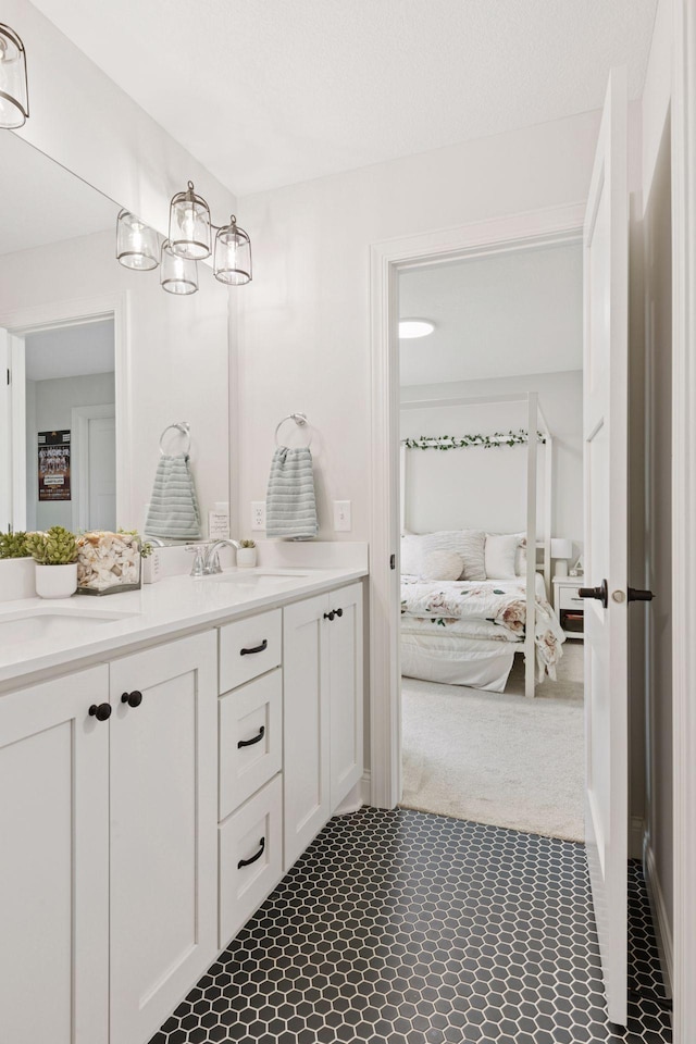 full bath with double vanity, ensuite bathroom, and a sink