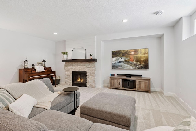 living area featuring a fireplace, light colored carpet, a textured ceiling, and recessed lighting