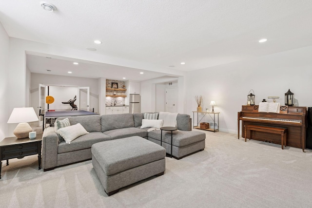 living room featuring light colored carpet, baseboards, bar, and recessed lighting