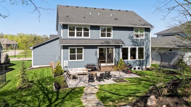 back of property featuring a patio area, a shingled roof, an outdoor hangout area, and a lawn