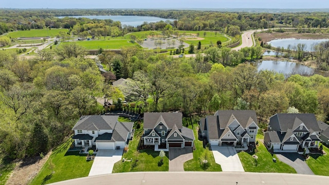 drone / aerial view with a water view and a residential view