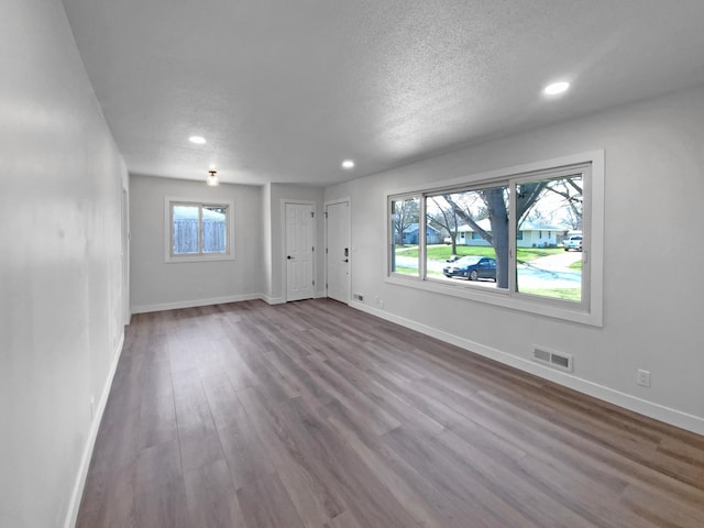 11601 Wren St NW, Coon Rapids, MN 55433 - unfurnished living room featuring recessed lighting, baseboards, dark wood finished floors, and a textured ceiling