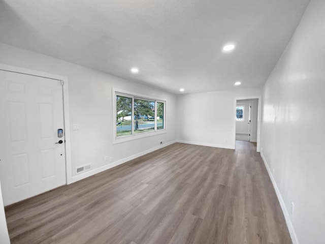 11601 Wren St NW, Coon Rapids, MN 55433 - unfurnished living room with wood finished floors, recessed lighting, and baseboards