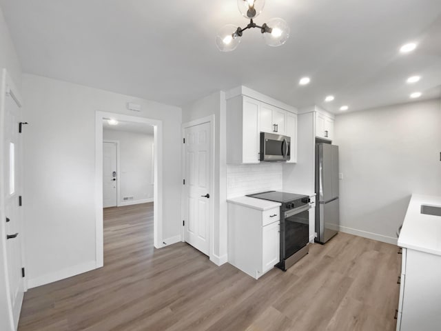 11601 Wren St NW, Coon Rapids, MN 55433 - kitchen with appliances with stainless steel finishes, light wood-type flooring, baseboards, backsplash, and light countertops