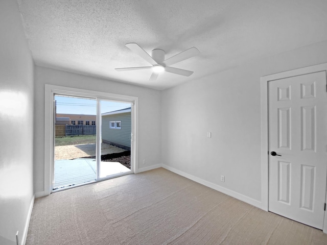 11601 Wren St NW, Coon Rapids, MN 55433 - empty room with light carpet, ceiling fan, baseboards, and a textured ceiling