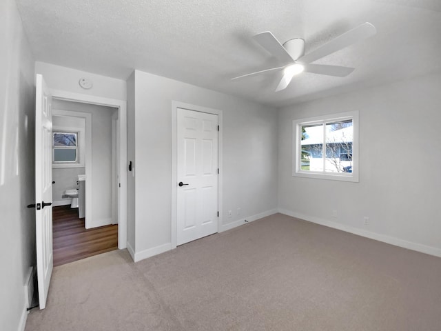 11601 Wren St NW, Coon Rapids, MN 55433 - unfurnished bedroom featuring carpet flooring, baseboards, ceiling fan, and a textured ceiling
