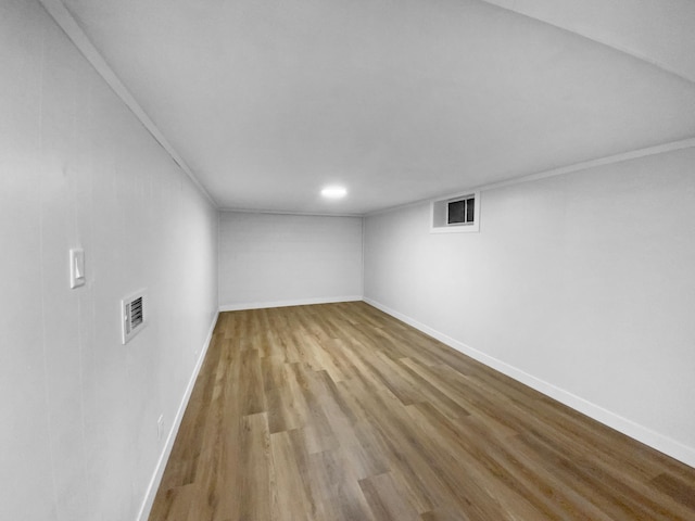 11601 Wren St NW, Coon Rapids, MN 55433 - finished below grade area featuring wood finished floors and baseboards